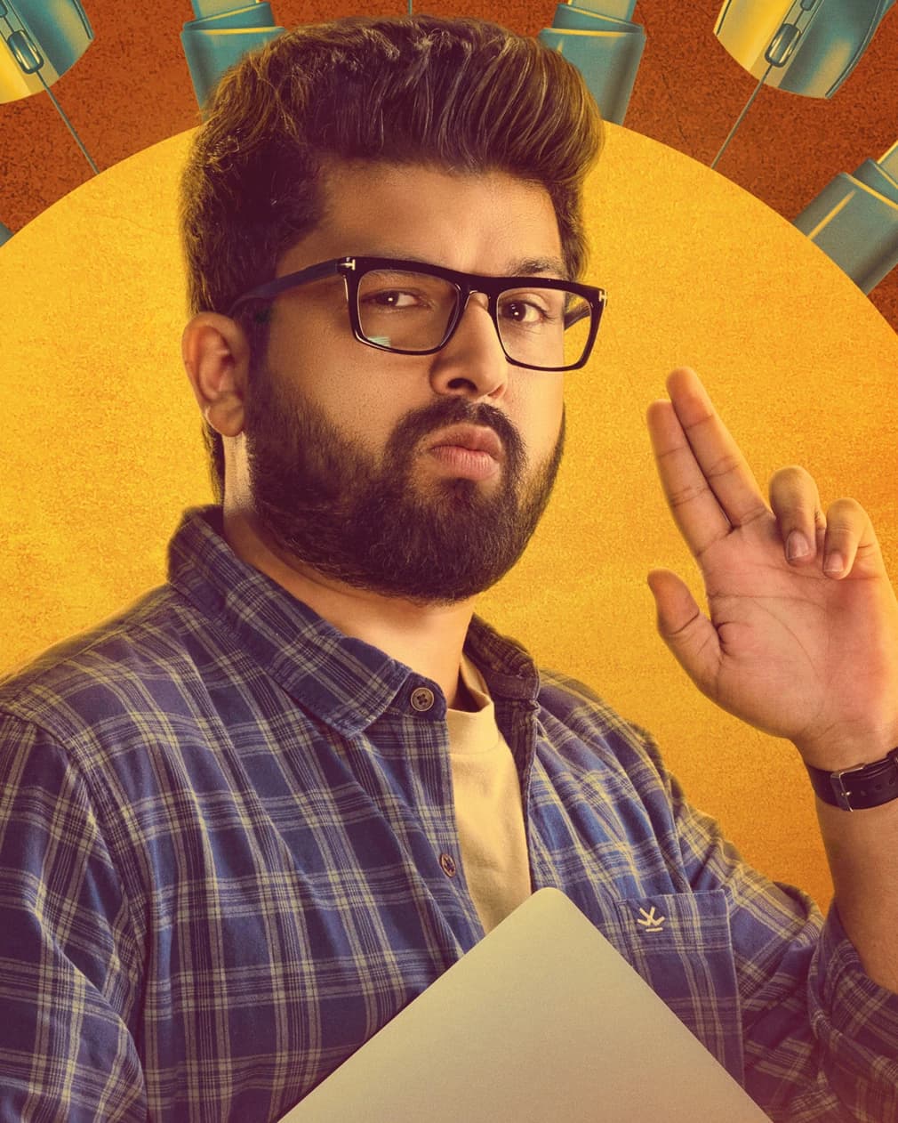 Deep Vaidya wearing glasses and a checked shirt in a promotional portrait