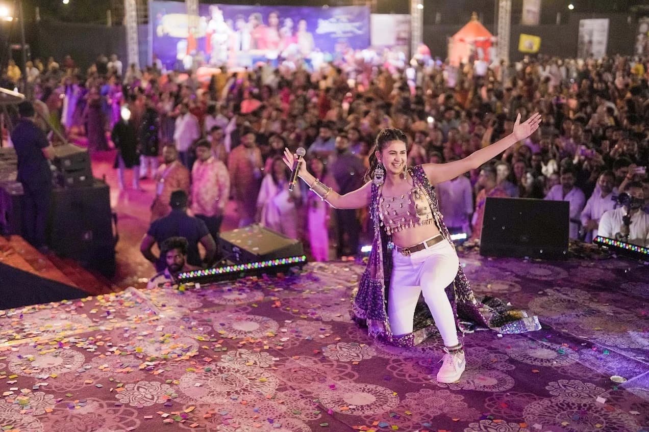 Kinjal Dave on a confetti-covered stage in front of a celebrating crowd at Killol.