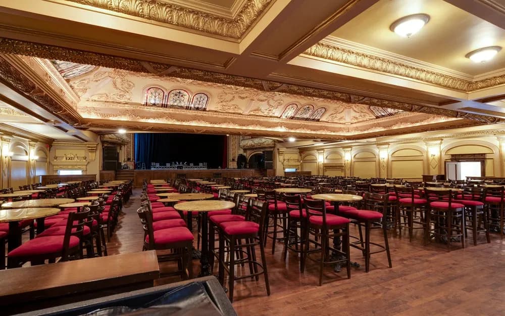 Ornate interior and cabaret tables in the main Théâtre Rialto auditorium